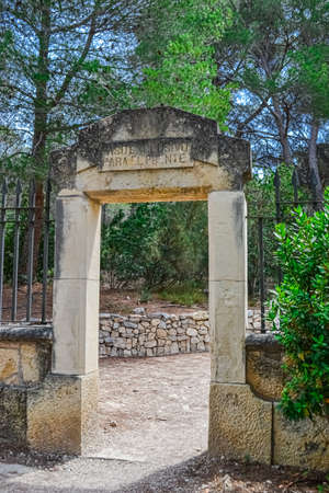 an ancient stone entrance with an inscription in Spanish to the site of the Roman aqueduct in Tarragona spain.のeditorial素材