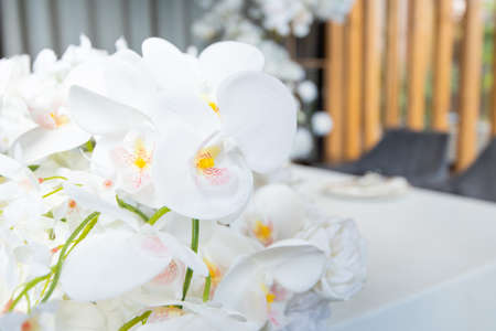 Lush floral arrangement on wedding table. Banquet table for newlyweds with flowers.の写真素材