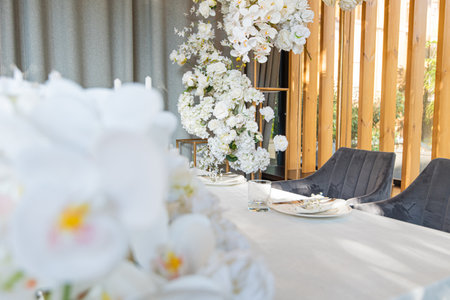 Lush floral arrangement on wedding table. Banquet table for newlyweds with flowers.の写真素材