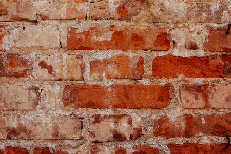 Old brick wall background, brick wall texture, structure. old broken brick, cement joints, close-up. crumbling from old age. construction, repair. concept of devastation, decline.の写真素材