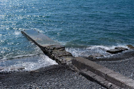 shore with the pier of the Black Sea with bright blue water on a clear sunny day.の写真素材