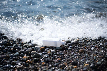 beach pollution. Plastic bottles trash on sea beach. ecological concept. earth day concept. globe pollution. Garbage on the beach. plastic at the ocean.の写真素材