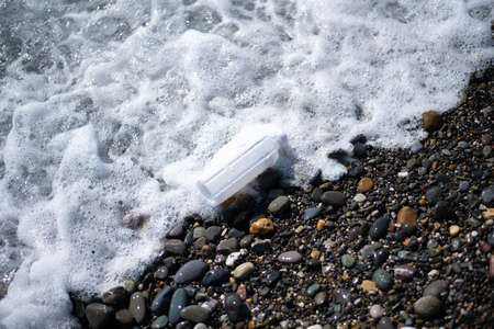beach pollution. Plastic bottles trash on sea beach. Garbage on the beach. plastic at the ocean.の写真素材