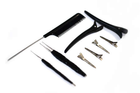 tools for braiding dreadlocks on a white background. hooks, comb and hairpins.
