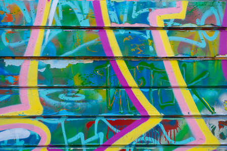 Graffiti bright colored old plastered. Closeup of colorful messy painted urban wall texture. Modern pattern for wallpaper design. Creative urban city background. abstract open composition.のeditorial素材
