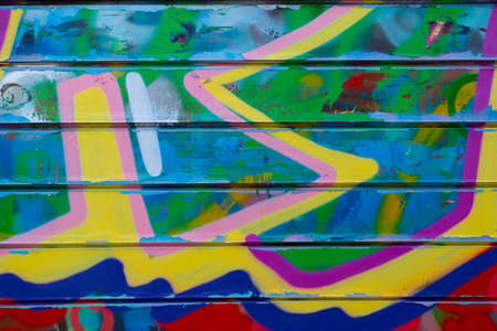 Graffiti bright colored old plastered. Closeup of colorful messy painted urban wall texture. Modern pattern for wallpaper design. Creative urban city background. abstract open composition.のeditorial素材