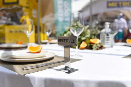 Reserved plate on an arranged restaurant table, toned image.の写真素材
