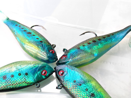 close up shot of green fish lures with sharp hooksの写真素材