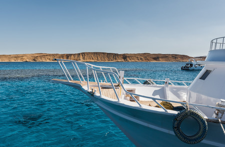 View at the coral sea and white yacht. Perfect place for snorkeling. Summer vacation at sea with turquoise clear water. Red sea with clear turquoise water.の写真素材