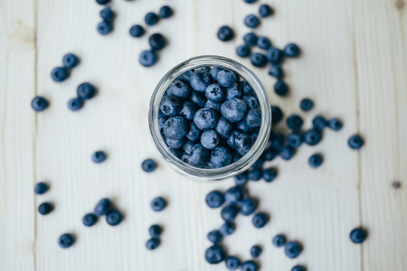 Top view of a rustic healthy breakfast with blueberry in a glass on a wooden table.の写真素材