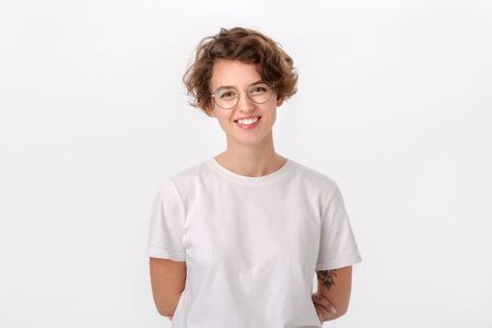 Pretty smiling woman in white shirt and eyeglasses isolated over white background. Positive emotionの写真素材