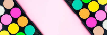 Bright neon eyeshadow palette on trendy pastel pink background. Make-up. Tool for makeup artist. Cosmetic.の写真素材