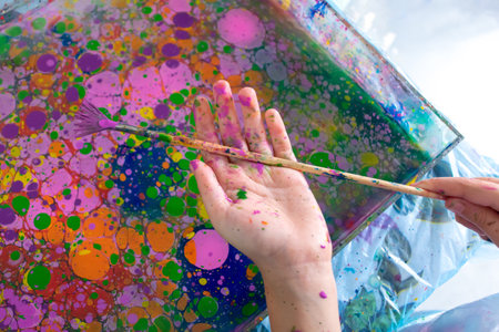 Ebru painting on water. Ancient Turkish art. Abstract bright multi-colored background. Photo liquid...
