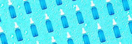 Moisturizing serum in glass bottle with white pipette on blue background with drops. Hyaluronic acid...