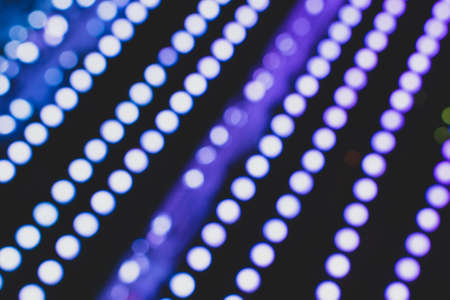 Christmas lights. Xmas. Festive New Year blurred purple and black background. Beautiful sparkling backdrop, texture. Bokeh. Copy space. Template. Trendy shades.の写真素材