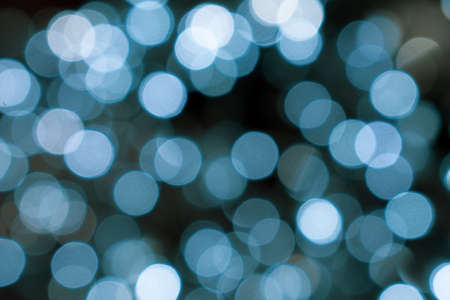 Christmas lights. Xmas. Festive New Year blurred blue and black background. Beautiful sparkling...