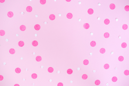 Pink background with pink round confetti. Festive background for your design. Flat lay style.の写真素材