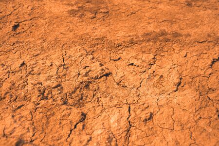 Dried clay background. Brown and cracked soil background. Clay. Ocher.
