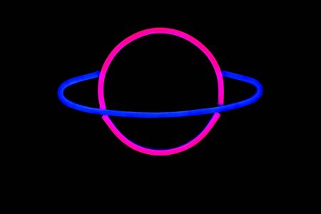 A bright glowing neon sign of Saturn isolated on black background. Neon sign.の写真素材