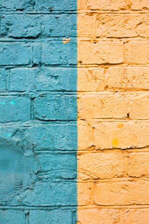Brick wall in yellow and green. Stripes up. A place for your designの写真素材
