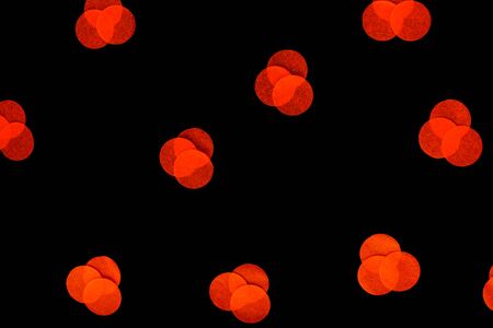 Halloween holiday background with orange confetti on an isolated black background. Flat lay style....