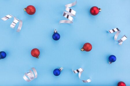 New year and Christmas concept. Christmas balls on blue background. Flat lay, copy space, top view. Christmas composition.の写真素材