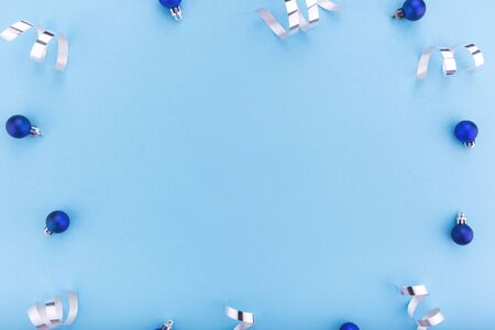 New year and Christmas concept. Christmas balls on blue background. Flat lay, copy space, top view. Christmas composition.の写真素材