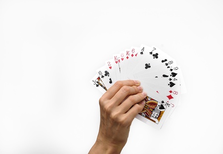 	Human hand with poker cards isolated on white backgroundsの写真素材