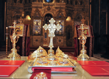 Crosses , rings and crowns of gold on the table in church  Wedding celebrationの写真素材