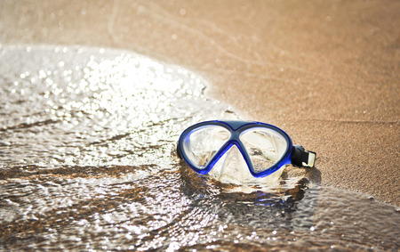 Blue swimming mask on sea beach  Face mask on the beachの写真素材