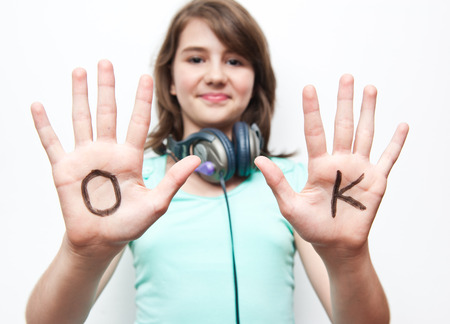 teen girl have fun with her hands. Focus on handsの写真素材