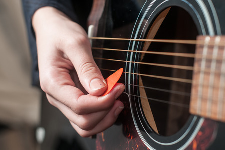 Female hand playing acoustic guitar.guitar play.Close up of guitarist hand playing acoustic guitarの写真素材