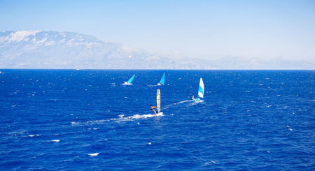 Sailing boats during beautiful sunny day against azure sea and blue sky. Zakynthos Island in Greece. Wind sailing boat in the blue seaの写真素材