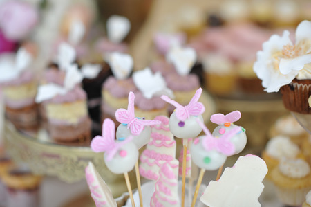 Wedding decoration with pastel colored cupcakes, meringues, muffins and macarons. Elegant and luxurious event arrangement with colorful macaroons. Wedding dessert with macaroonsの写真素材