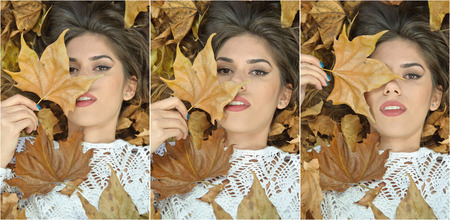 Nice girl covered with autumnal leaves. Young woman laying down on the ground covered by fall foliage in park. Beautiful sexy girl lying on autumn leaves. Young woman covered with golden autumn leavesの写真素材