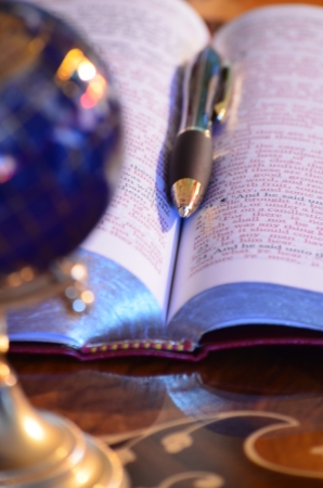 Globe, bible and penの写真素材