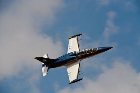 L39 Jet in flight in semi cloud