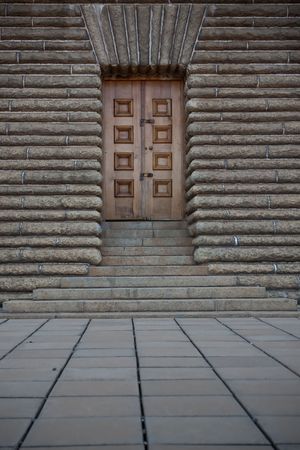 beautiful wooden door set in a thick stone wallの写真素材