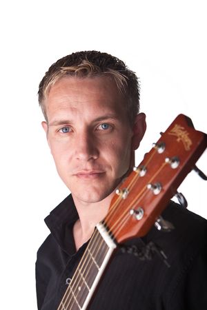 Young Man with guitar with serious look on white lit background