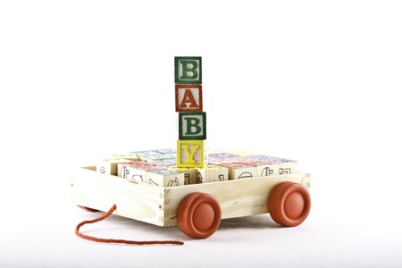 kids wooden alphabet letter set in a wooden box with wheels with cubes spelling the word babyの写真素材
