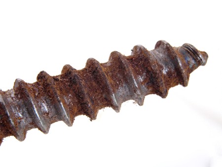 Old rusty screw on a white background.の写真素材