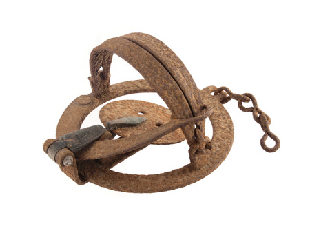 Close up photo of a rusty vermin trap on a white background.の写真素材