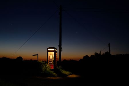 public telephone box at sunset in the countrysideの写真素材