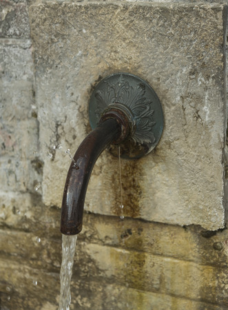 Water. Fountains in the Woods. Italy. Campania. Cilento. Gulf of Policastro. Two jets of water into a powerful body, red brick. White stone square corner. Fresh, current, strong and cold spurts.の写真素材
