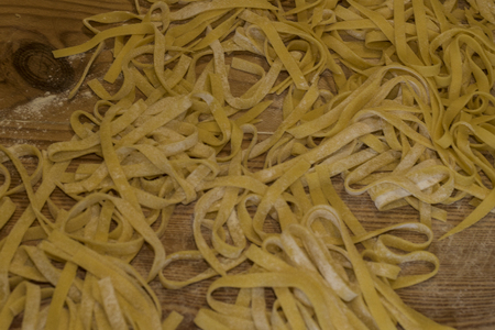 Noodles Italian PASTA, egg noodles with wheat flour. Puff and flap cut, homemade. Traditional pasta of Campania IT The Bottom of canavas or of wood dust with flour.の写真素材