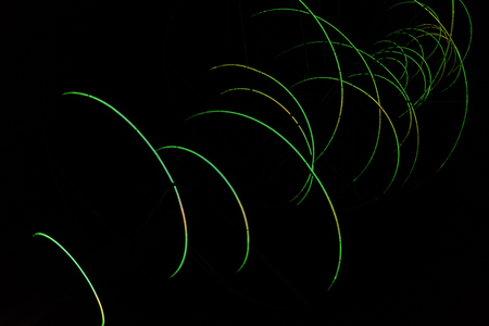 Colored arches intersect in the night, red, yellow, blue, green. Colored trajectories, anomalous comets.の写真素材