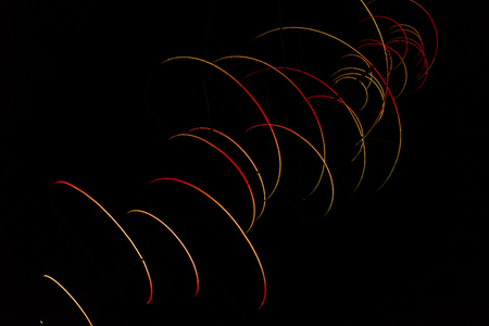 Colored arches intersect in the night, red, yellow, blue, green. Colored trajectories, anomalous comets.の写真素材
