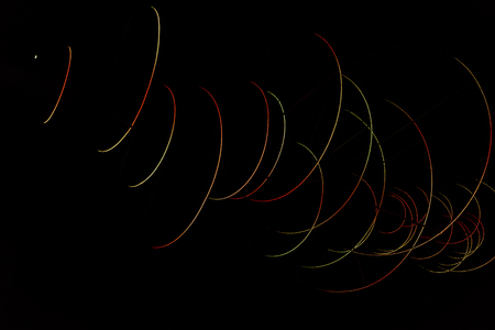 Colored arches intersect in the night, red, yellow, blue, green. Colored trajectories, anomalous comets.の写真素材