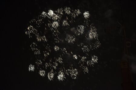 Fire stars, plays of light, clouds of smoke in the black sky of a summer night.の写真素材