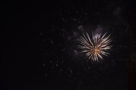 Fire stars, plays of light, clouds of smoke in the black sky of a summer night.の写真素材